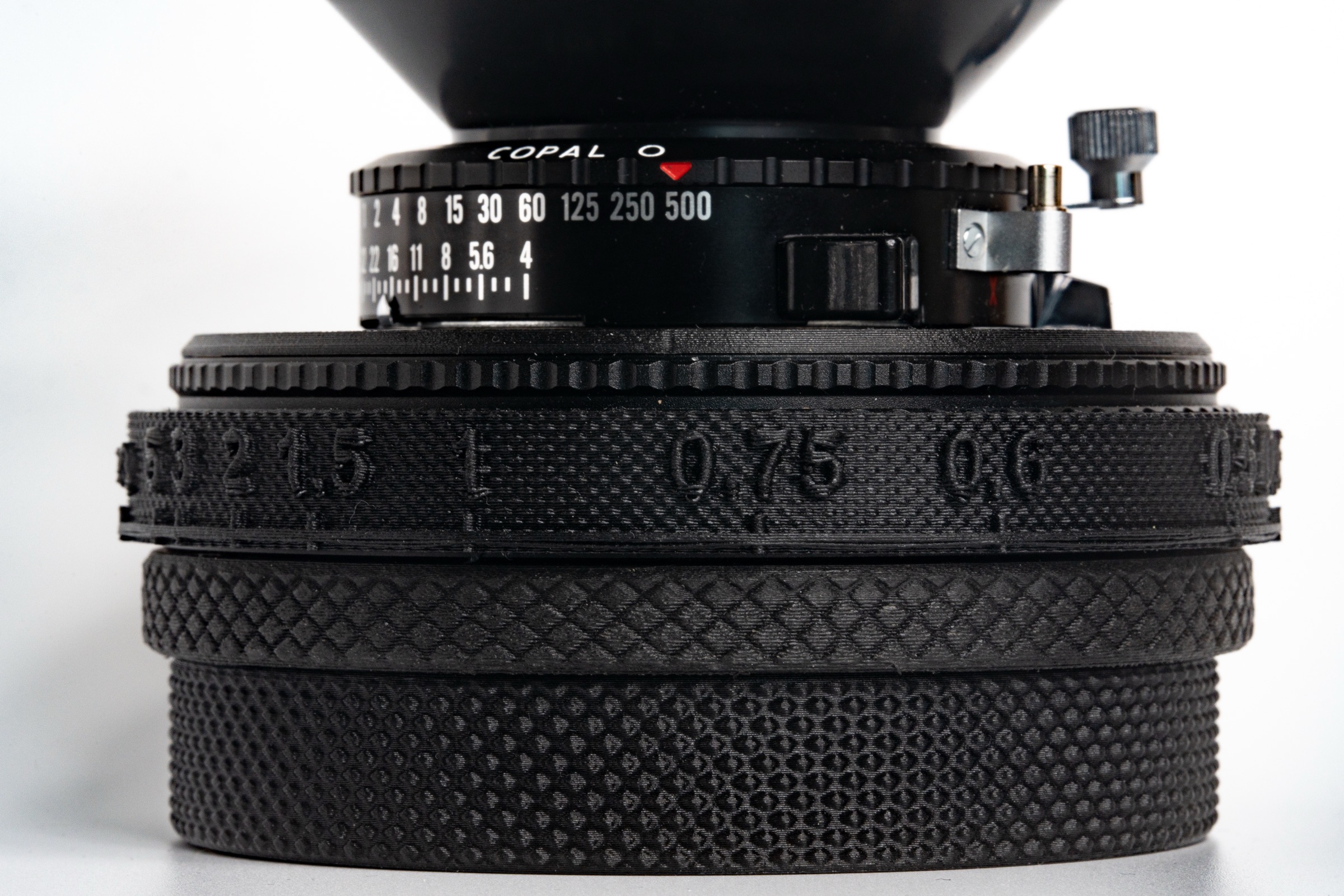 Close-up of the 3D-printed helicoid with engraved distance scale on a Nikkor SW 65 mm